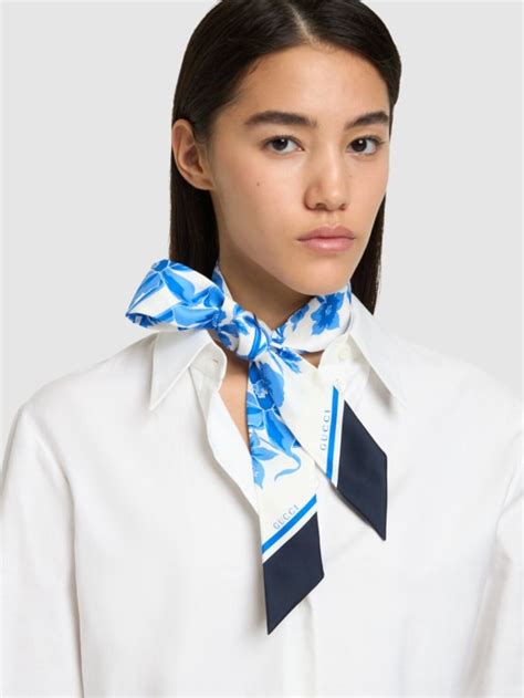 gucci silk neck bow with floral print|Floral print silk neck bow in light blue and white .